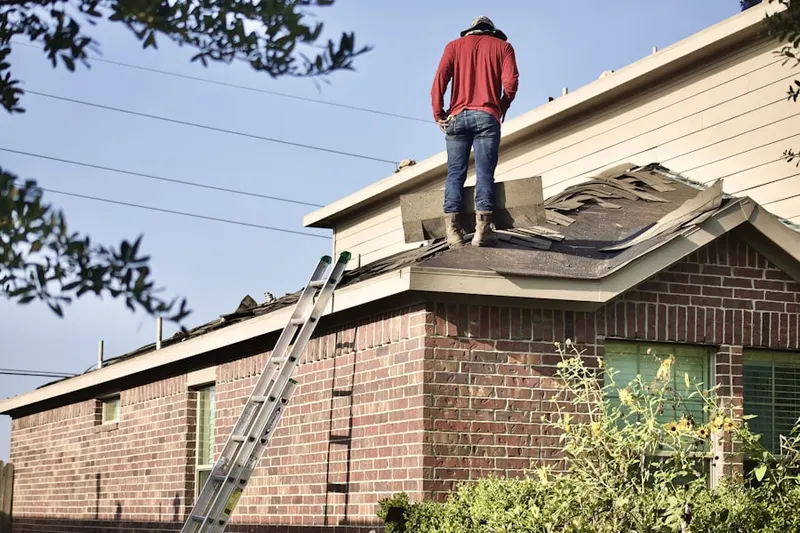 Professional roofer working on a residential roof in Wood Valley Estates